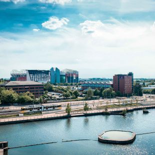 View of Trafford from above, featuring the Trafford waterside and Old Trafford stadium.
